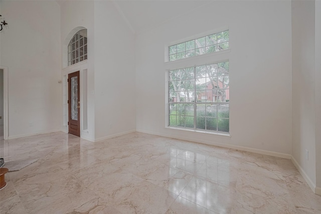 1615 Monvale Ln, Sugar Land, TX 77479 - spare room with high vaulted ceiling and marble tiled floors