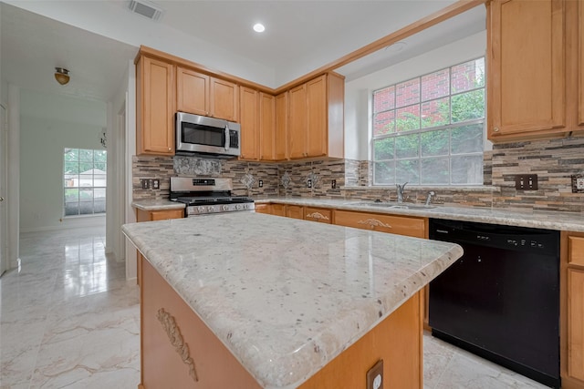1615 Monvale Ln, Sugar Land, TX 77479 - kitchen with stainless steel appliances, backsplash, light stone counters, and recessed lighting