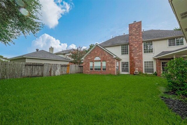 1615 Monvale Ln, Sugar Land, TX 77479 - rear view of property with brick siding and a chimney