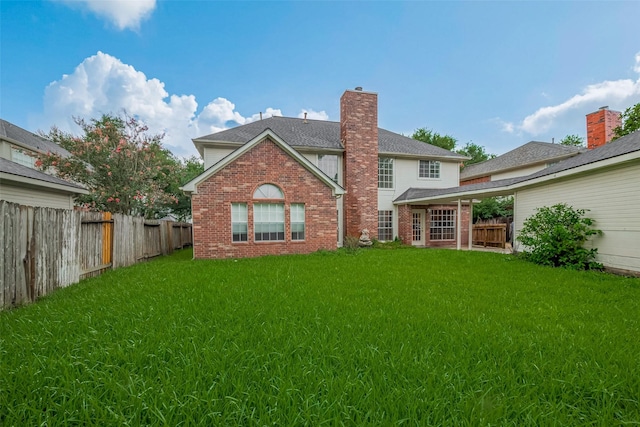 1615 Monvale Ln, Sugar Land, TX 77479 - rear view of property with brick siding, a fenced backyard, and a chimney