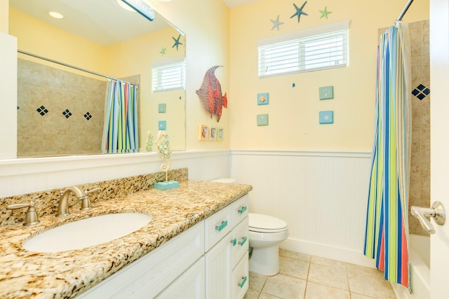 22831 Gulf Dr, Galveston, TX 77554 - full bath featuring a wainscoted wall, vanity, tile patterned flooring, and shower / bath combination with curtain