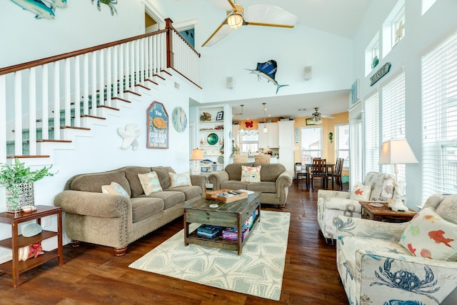 22831 Gulf Dr, Galveston, TX 77554 - living area with ceiling fan, wood finished floors, high vaulted ceiling, and stairs