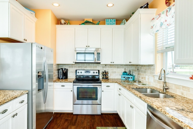 22831 Gulf Dr, Galveston, TX 77554 - kitchen featuring appliances with stainless steel finishes, dark wood-style floors, decorative backsplash, white cabinets, and recessed lighting