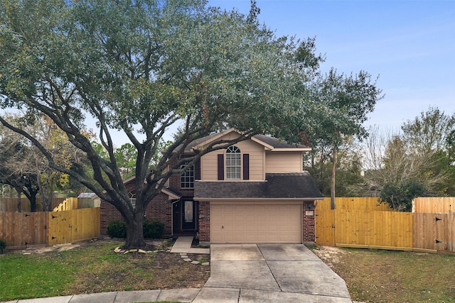 9135 Eaglecove Dr, Houston, TX 77064 - traditional home with a gate, brick siding, a garage, and driveway