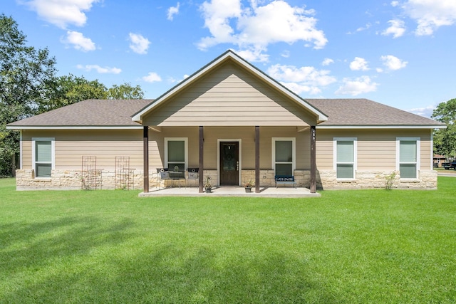 468 Brahman, Onalaska, TX 77360 - rear view of property with stone siding, a lawn, a patio area, and a shingled roof
