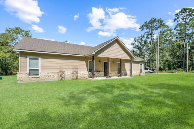 468 Brahman, Onalaska, TX 77360 - rear view of house featuring stone siding, a yard, and a patio