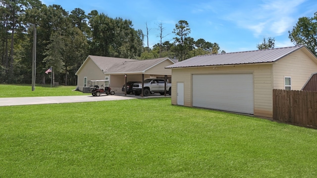 468 Brahman, Onalaska, TX 77360 - rear view of property with a detached garage, an outdoor structure, a metal roof, and driveway