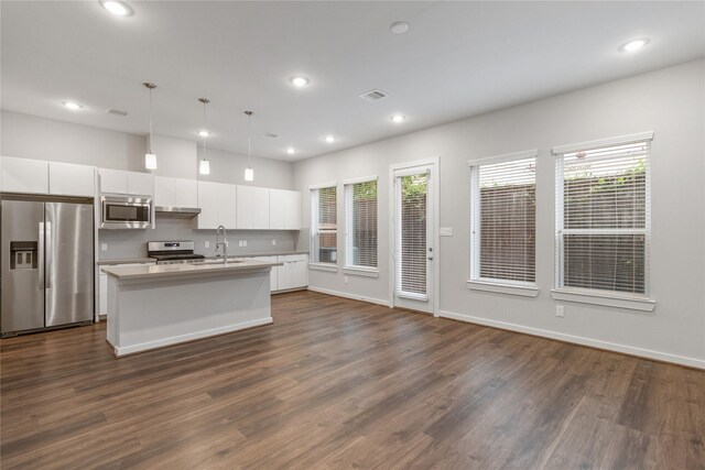 602 Thornton Rd Unit D, Houston, TX 77018 - kitchen featuring appliances with stainless steel finishes, white cabinetry, dark wood finished floors, an island with sink, and recessed lighting