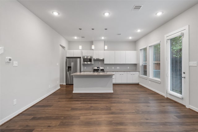 602 Thornton Rd Unit D, Houston, TX 77018 - kitchen with stainless steel appliances, a kitchen island with sink, white cabinetry, recessed lighting, and dark wood-type flooring