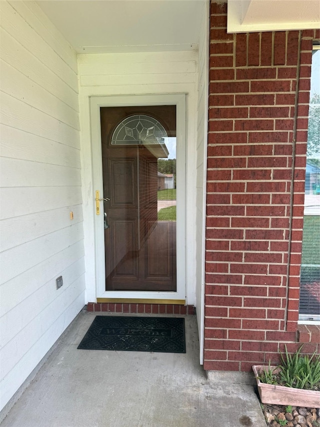 1140 Thomas Dr, Angleton, TX 77515 - view of exterior entry featuring brick siding
