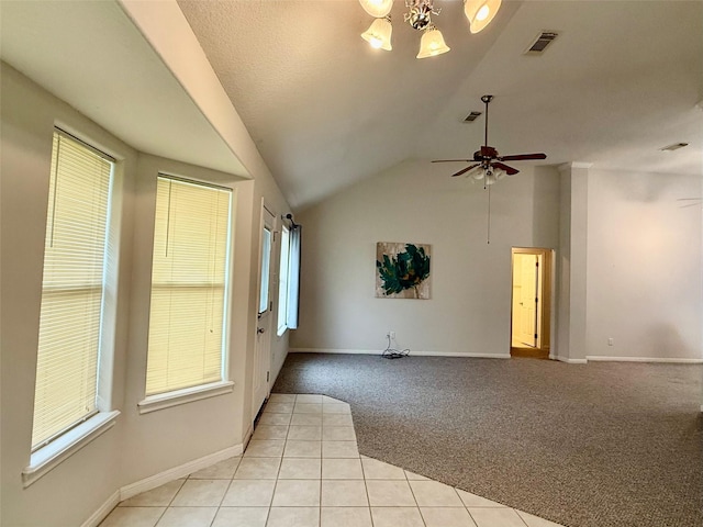1140 Thomas Dr, Angleton, TX 77515 - empty room with light carpet, lofted ceiling, a chandelier, light tile patterned floors, and ceiling fan