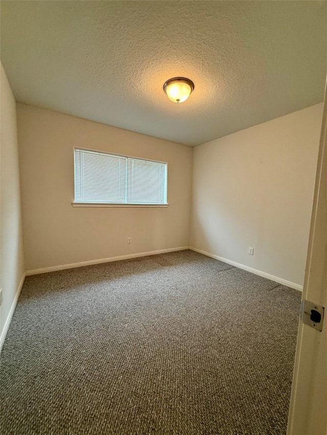 1140 Thomas Dr, Angleton, TX 77515 - empty room featuring carpet flooring and a textured ceiling