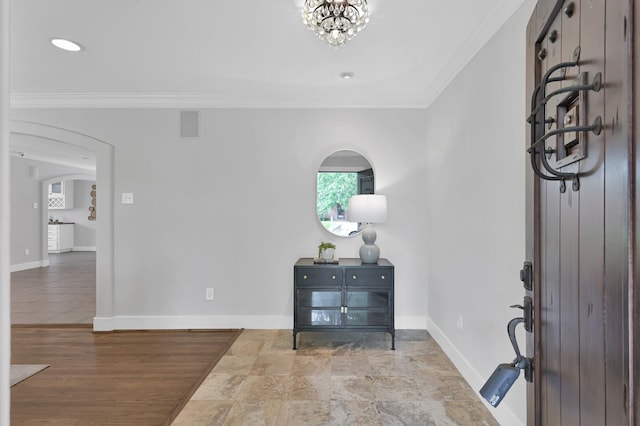 4310 Wigton Dr, Houston, TX 77096 - entrance foyer with ornamental molding, arched walkways, and a chandelier