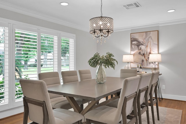 4310 Wigton Dr, Houston, TX 77096 - dining space featuring crown molding, a chandelier, wood finished floors, and recessed lighting