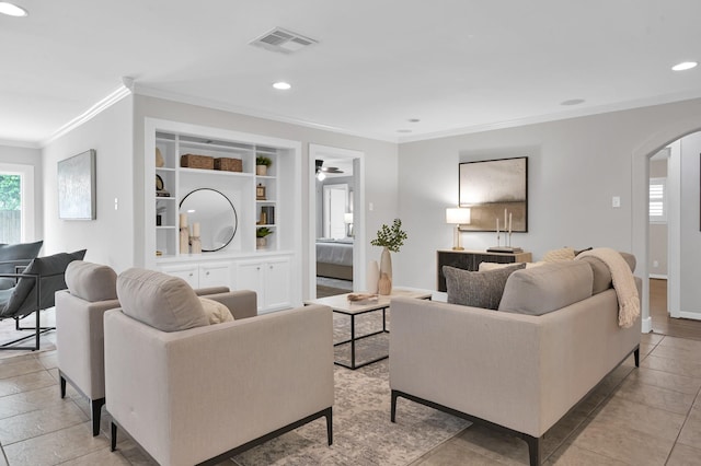 4310 Wigton Dr, Houston, TX 77096 - living room with ornamental molding, arched walkways, built in shelves, recessed lighting, and ceiling fan