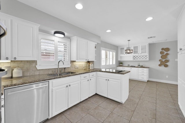 4310 Wigton Dr, Houston, TX 77096 - kitchen with stainless steel dishwasher, a peninsula, tasteful backsplash, black electric stovetop, and white cabinets