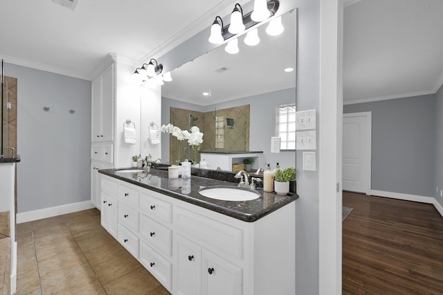 4310 Wigton Dr, Houston, TX 77096 - full bathroom featuring tiled shower, double vanity, and ornamental molding