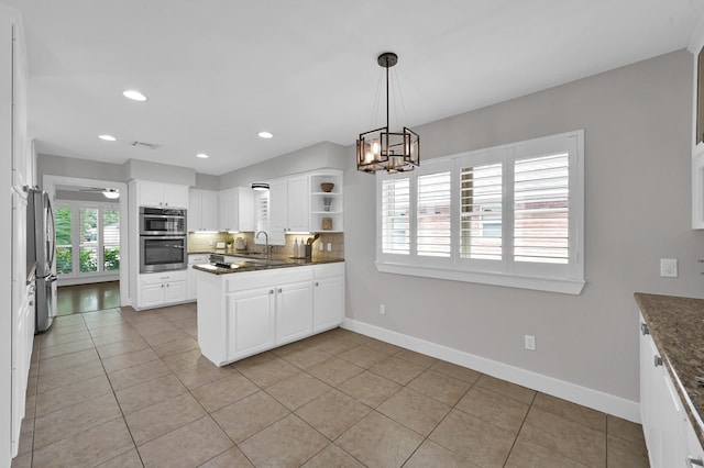 4310 Wigton Dr, Houston, TX 77096 - kitchen with plenty of natural light, appliances with stainless steel finishes, open shelves, white cabinetry, and recessed lighting