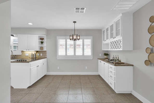 4310 Wigton Dr, Houston, TX 77096 - kitchen featuring open shelves, white cabinetry, backsplash, glass insert cabinets, and recessed lighting
