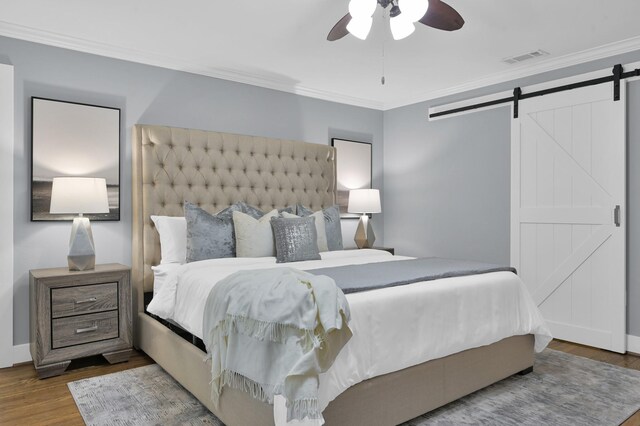 4310 Wigton Dr, Houston, TX 77096 - bedroom featuring a barn door, wood finished floors, crown molding, and a ceiling fan