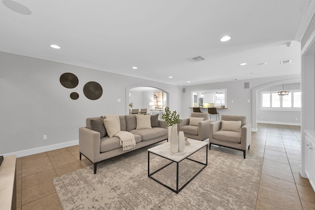 4310 Wigton Dr, Houston, TX 77096 - living area featuring arched walkways, ornamental molding, recessed lighting, light tile patterned floors, and a chandelier