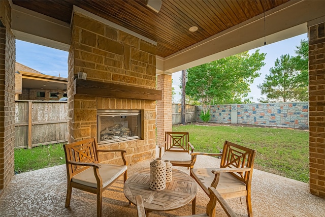 2418 Sandhill Crest Ln, Brookshire, TX 77423 - fenced backyard featuring an outdoor stone fireplace and a patio area