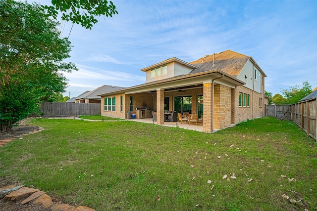 2418 Sandhill Crest Ln, Brookshire, TX 77423 - rear view of house with ceiling fan, a patio, a fenced backyard, and brick siding