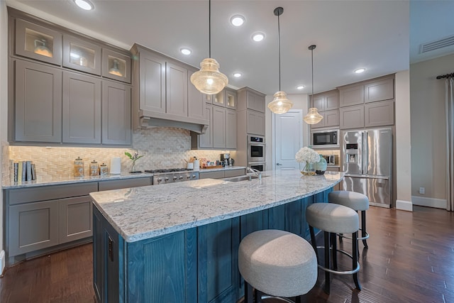 2418 Sandhill Crest Ln, Brookshire, TX 77423 - kitchen with appliances with stainless steel finishes, gray cabinets, dark wood-style flooring, tasteful backsplash, and recessed lighting