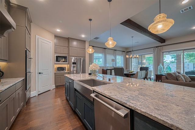 2418 Sandhill Crest Ln, Brookshire, TX 77423 - kitchen with stainless steel appliances, gray cabinets, dark wood-style floors, healthy amount of natural light, and beam ceiling