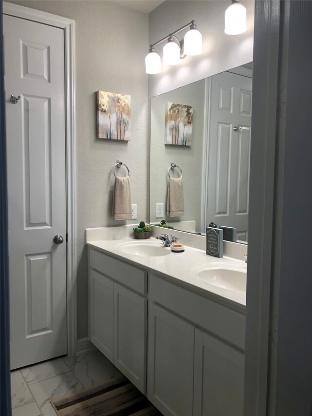 9470 Caddo Ridge Ln, Cypress, TX 77433 - bathroom with double vanity and marble look tiles