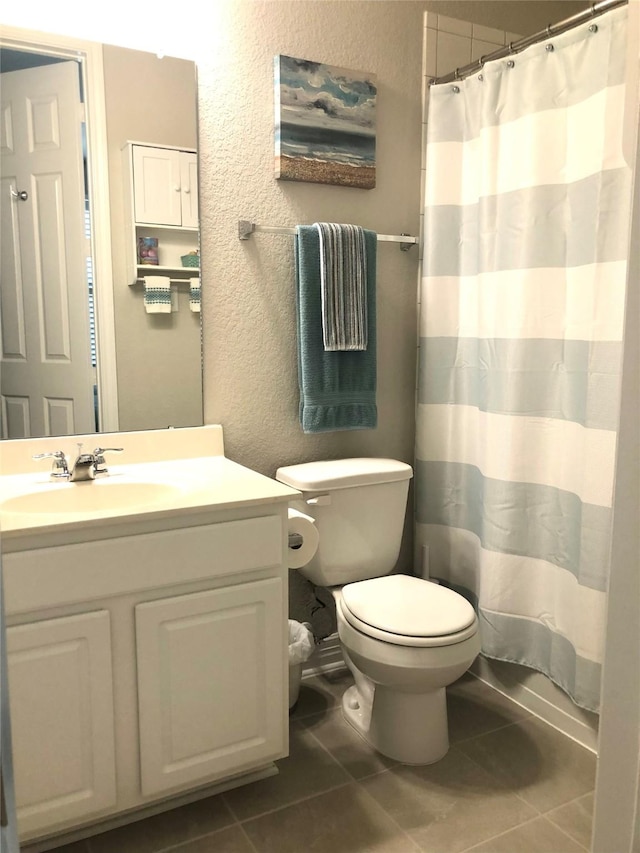 9470 Caddo Ridge Ln, Cypress, TX 77433 - bathroom featuring a textured wall, vanity, tile patterned flooring, and a shower with curtain
