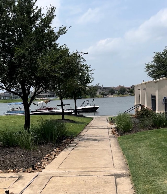 9470 Caddo Ridge Ln, Cypress, TX 77433 - view of property's community featuring a water view, a lawn, and a boat dock