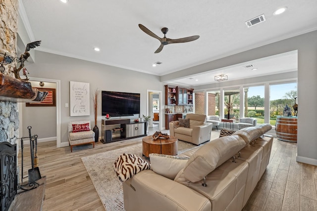 25 The Oval St, Sugar Land, TX 77479 - living room with ornamental molding, a ceiling fan, light wood-style flooring, and recessed lighting
