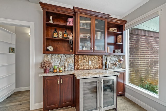 25 The Oval St, Sugar Land, TX 77479 - indoor dry bar featuring beverage cooler, light wood finished floors, tasteful backsplash, and ornamental molding