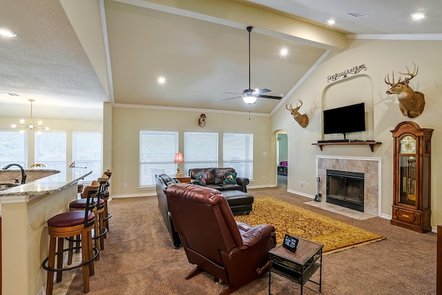 130 Canary Ln, Coldspring, TX 77331 - carpeted living room featuring ceiling fan, a fireplace, healthy amount of natural light, arched walkways, and ornamental molding