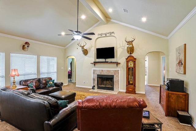 130 Canary Ln, Coldspring, TX 77331 - living room featuring arched walkways, ceiling fan, light carpet, a tile fireplace, and ornamental molding