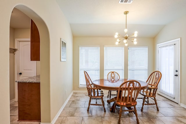 130 Canary Ln, Coldspring, TX 77331 - dining room with lofted ceiling, arched walkways, and a chandelier