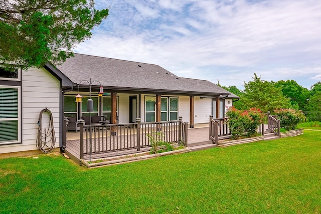 130 Canary Ln, Coldspring, TX 77331 - back of property featuring a yard, a shingled roof, and a wooden deck