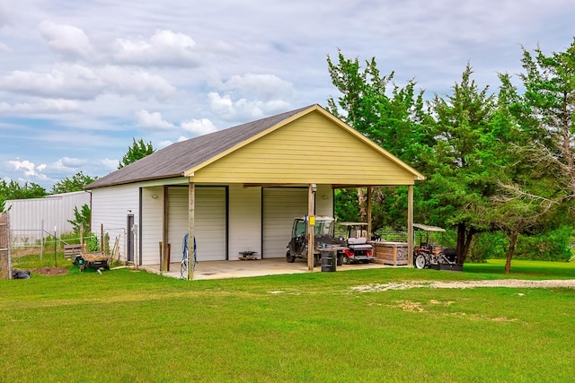 130 Canary Ln, Coldspring, TX 77331 - back of house featuring a detached garage and an outbuilding