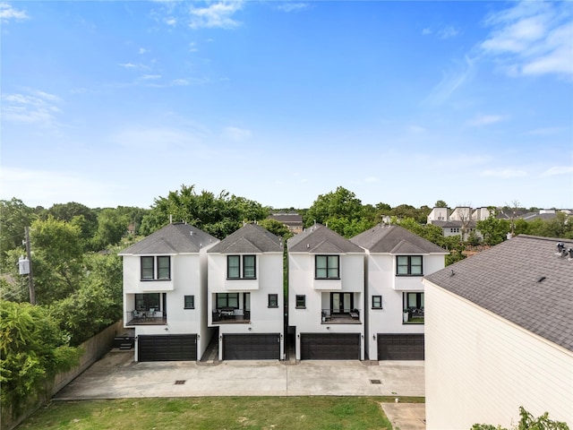 6617 Del Rio St Unit D, Houston, TX 77021 - rear view of property featuring an attached garage, a residential view, and stucco siding