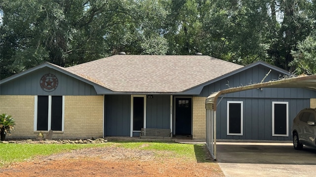 8228 Ponderosa Dr, Silsbee, TX 77656 - single story home featuring roof with shingles, brick siding, a carport, and concrete driveway