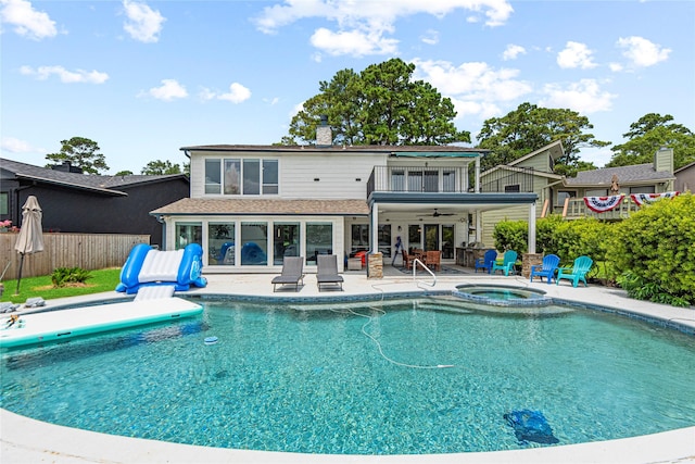 3114 Canterbury Ln, Montgomery, TX 77356 - back of house with ceiling fan, a patio, an in-ground hot tub, and a chimney