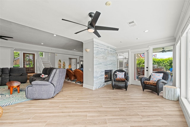 3114 Canterbury Ln, Montgomery, TX 77356 - living area with ornamental molding, a ceiling fan, a fireplace, recessed lighting, and light wood finished floors