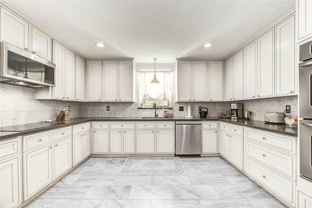 11715 Cypresswood Dr, Houston, TX 77070 - kitchen with appliances with stainless steel finishes, dark countertops, decorative backsplash, a textured ceiling, and recessed lighting