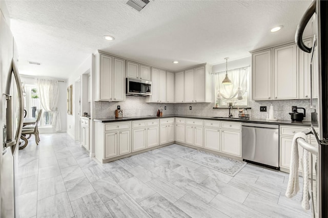 11715 Cypresswood Dr, Houston, TX 77070 - kitchen featuring stainless steel appliances, dark countertops, decorative backsplash, light marble finish flooring, and a textured ceiling