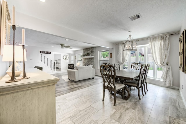 11715 Cypresswood Dr, Houston, TX 77070 - dining room featuring stairway, a chandelier, a textured ceiling, ceiling fan, and recessed lighting