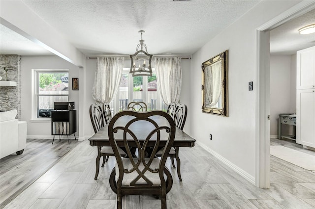 11715 Cypresswood Dr, Houston, TX 77070 - dining room featuring a chandelier and a textured ceiling