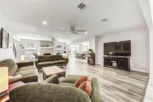 11715 Cypresswood Dr, Houston, TX 77070 - living area with light wood-type flooring, a ceiling fan, a fireplace, and recessed lighting