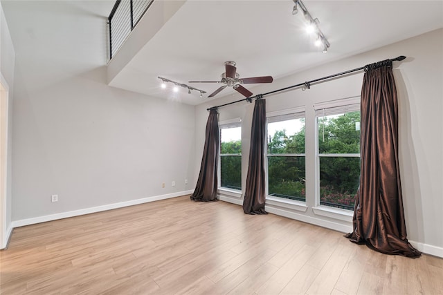 1616 Elgin St Unit 11, Houston, TX 77004 - empty room with rail lighting, ceiling fan, and light wood finished floors