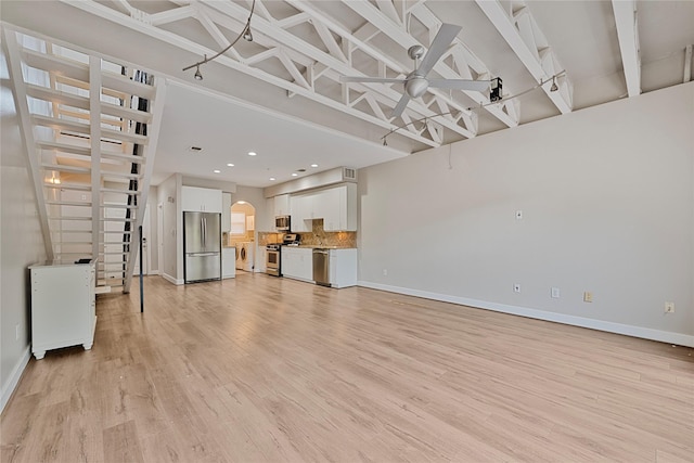 1616 Elgin St Unit 11, Houston, TX 77004 - unfurnished living room featuring ceiling fan, light wood-style floors, arched walkways, and recessed lighting